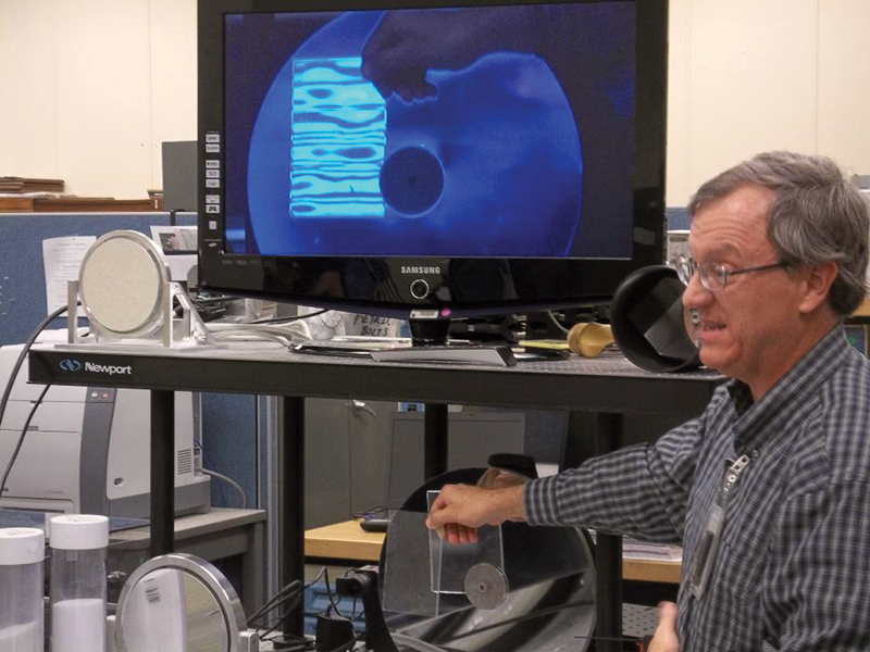 NASA's Bob Youngquist demonstrates a device for  detecting leaks.  Photo by Michael Harrington