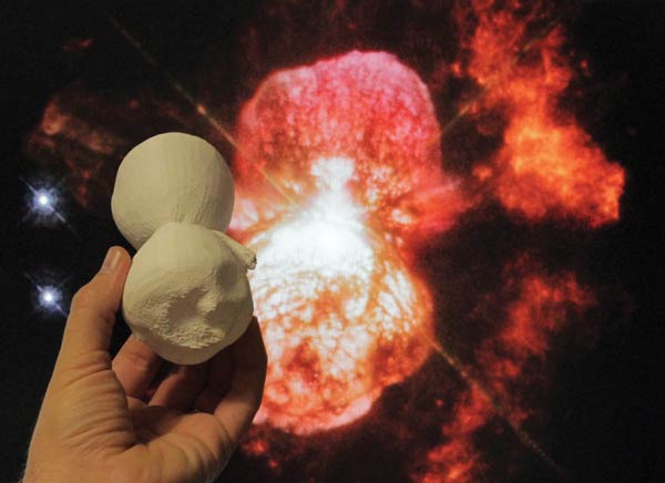 A 3-D printed model of the Homnculus Nebula is compared to a Hubble image of the object. Photo courtesy of NASA's Goddard Space Flight Center/Ed Campton