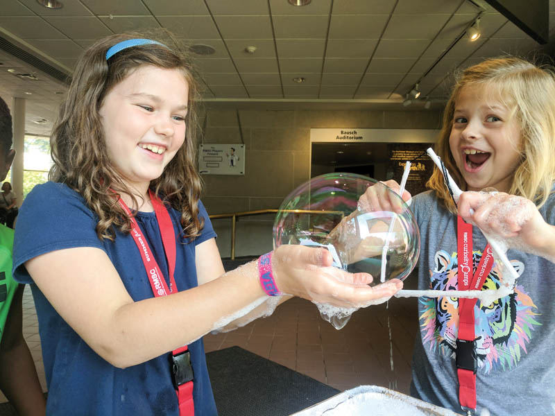 Who doesn’t love bubbles? Campers made giant bubbles and were then able to explain why they observed them to be rainbow colored using principles of interference. Photo by Samantha Tetef. 
