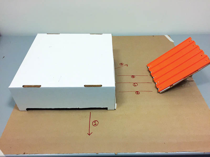 Figure 2 - With each roll, participants use a marker to trace the marble’s path as it travels in and out of the box. 