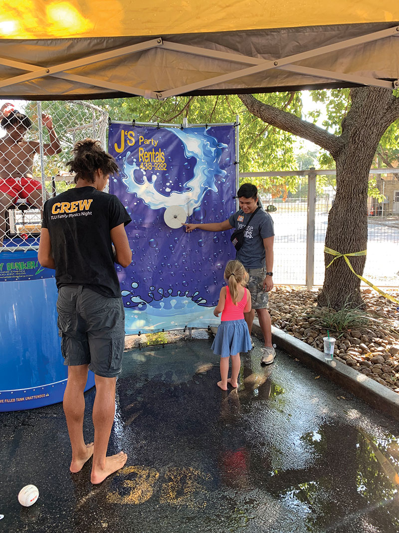 A Texas Lutheran SPS volunteer explains the dunk tank rules to an attendee. Photos courtesy of the SPS chapter of Texas Lutheran University.