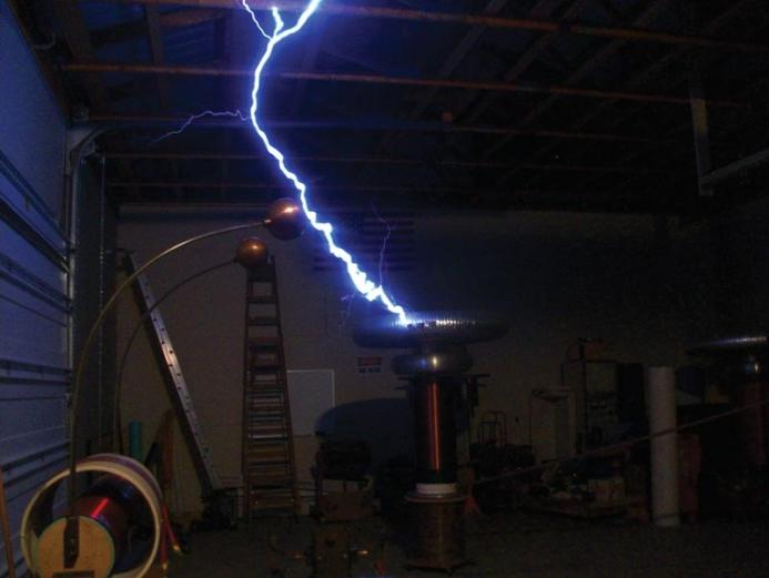 A Tesla coil in action generates a streak of man-made lightning. Photo by Andrew Carly. 