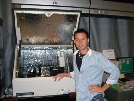 Anderson stands in front of a scanning probe microscope he frequently used during his 2005 SPS internship at NIST. Photos courtesy of Bridger Anderson.