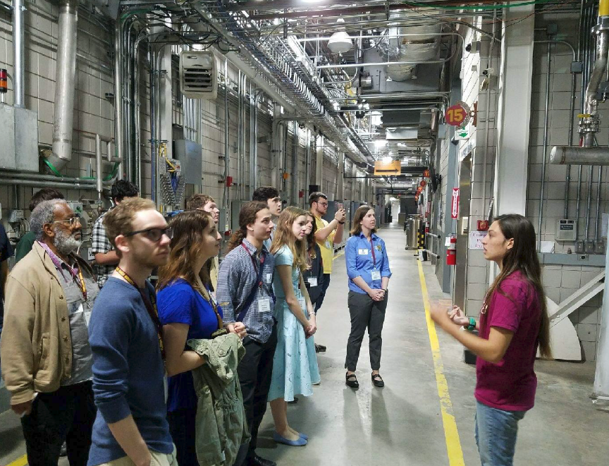 FSU Physics Major, Haley Reid, leads Zone 6 attendees on the tour of the National High Magnetic Field Laboratory.