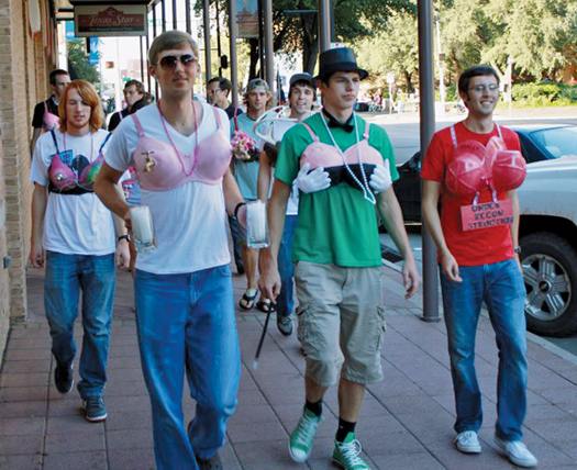 Abilene Christian University SPS members act as human canvases for a breast cancer awareness project. Photo by Tim Head.