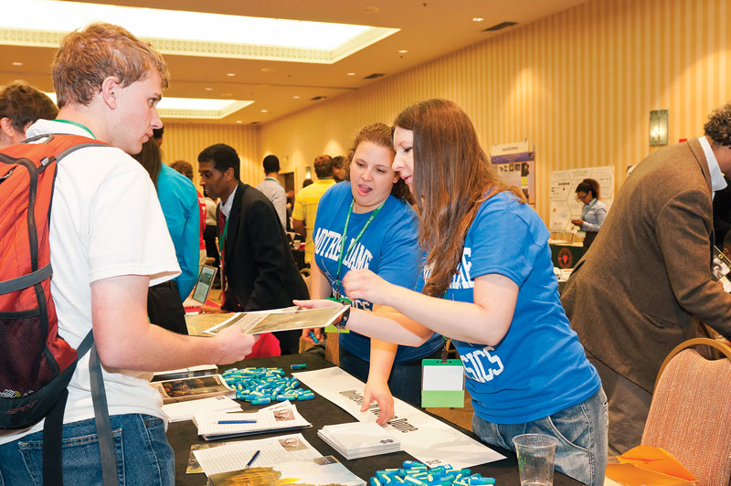 Sarah Reiff and Sylwia Ptasinska from the University of Notre Dame speak with a student in the Exhibit Hall.