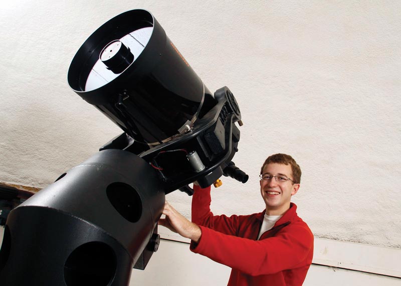 Josh Fuchs poses with the telescope at Rhodes College that he used in public outreach projects. Photo courtesy of Josh Fuchs.