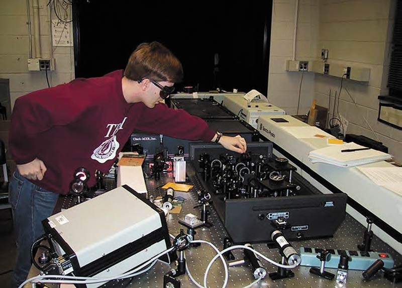 The author in transition… wearing his engineering honor society shirt while working in an ultrafast optics lab during his PhD training.