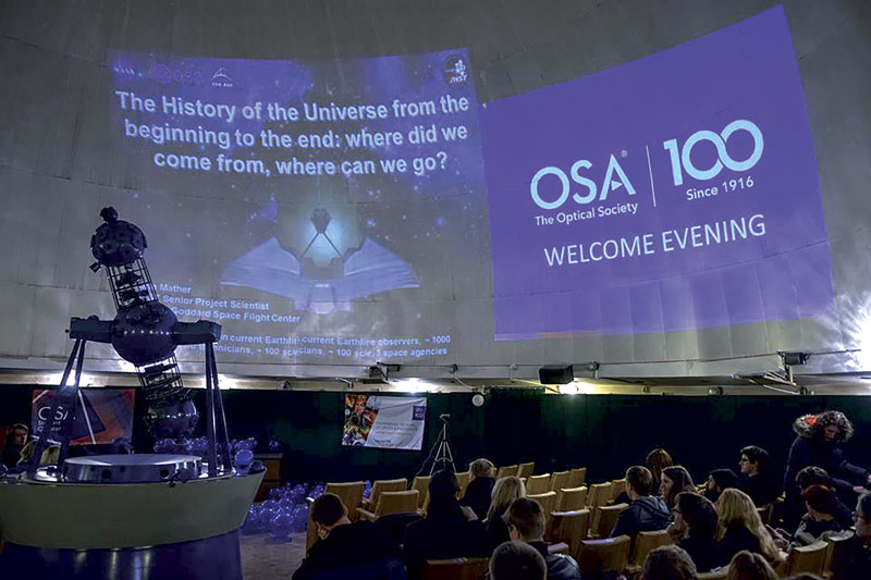 Attendees await the live broadcast of Nobel winner Prof. John C. Mather’s presentation at the “OSA Welcome Evening.” The event was hosted by the OSA student chapter of Vilnius University at the university’s planetarium. Photo courtesy of The Optical Society.