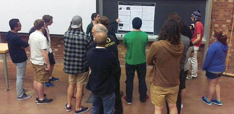 Eryn Cangi of University of Oregon presents her poster about astrophysical synchronization.