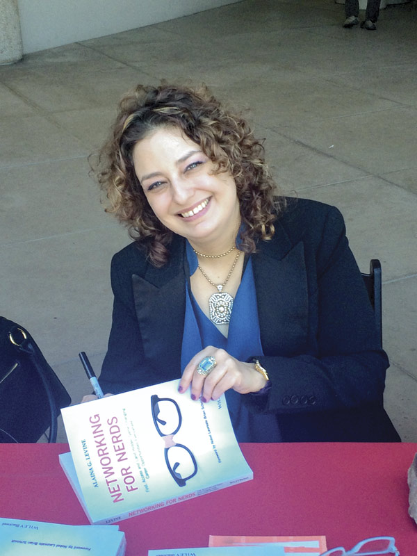 Levine signing copies of her book, Networking for Nerds, at the Tucson Festival of Books in 2016. The forward is written by Physics Nobel Laureate Brian Schmidt. Photo courtesy of Alaina G. Levine.