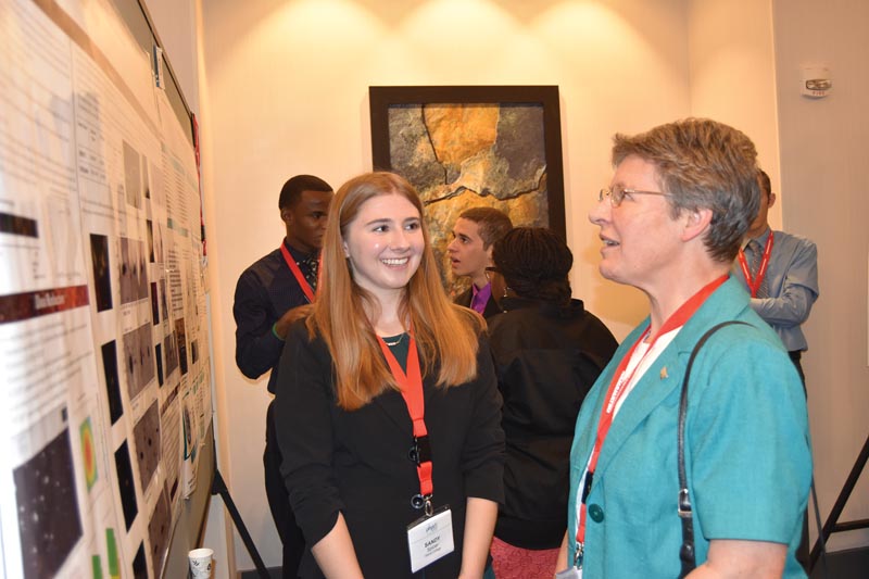 Sandy Spicer from Siena College takes questions from Dame Jocelyn Bell-Burnell at the poster sessions.