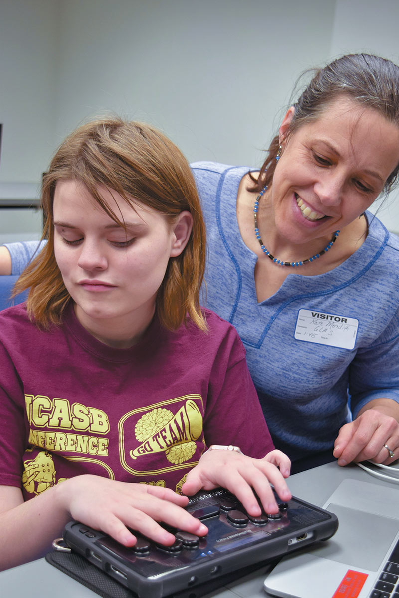 Elena Charles, an IDATA participant from the Wisconsin School for the Blind, helps Kate Meredith understand how astronomy software interacts with her new BrailleSense notetaker. Photo courtesy of Kate Meredith, GLAS Education.
