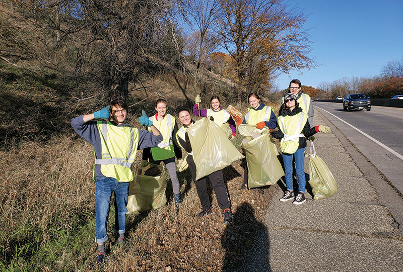 SPS members enjoy some sunshine while cleaning up along Highway 169.