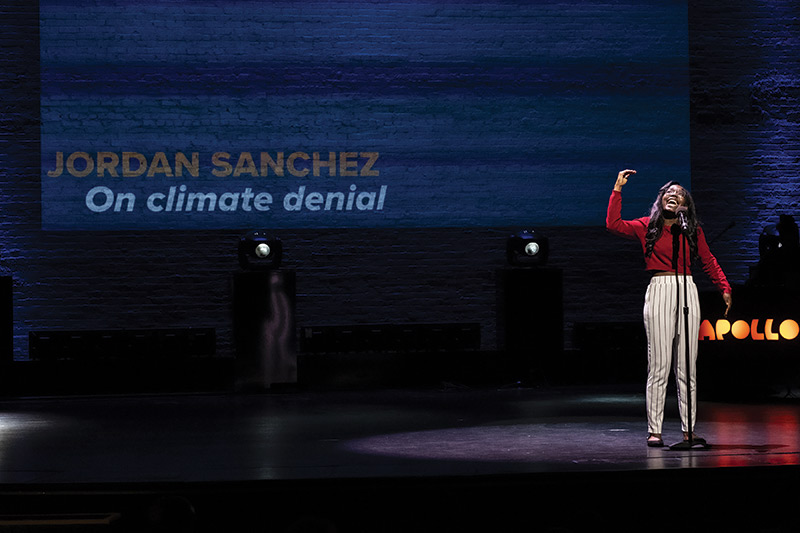 Sanchez performs her poem “On Climate Denial” onstage at the Apollo Theater.