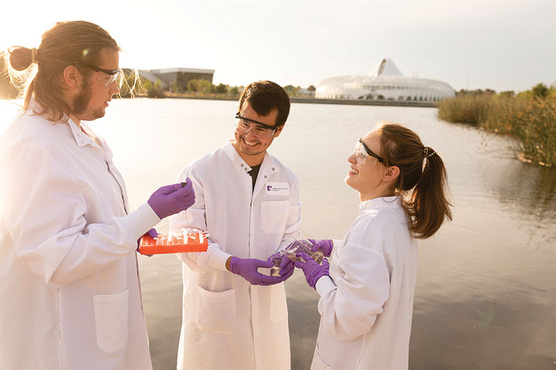 Students collect FL Poly pond water samples for the sunlight-assisted photocatalytic treatment.
