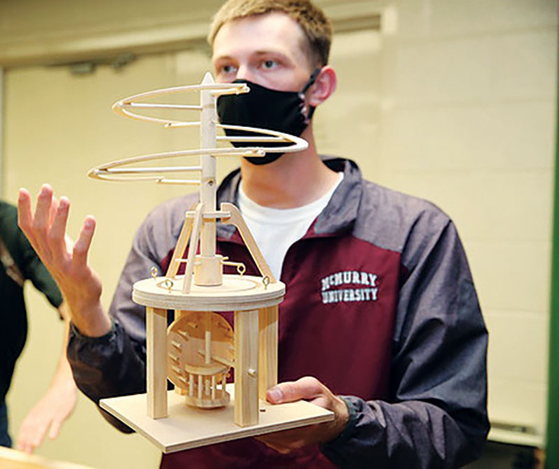 Jacob Williams discusses using a small craft model of Leonardo da Vinci’s helicopter as the basis for a larger scale model. Photo courtesy of the McMurry Advancement Office.