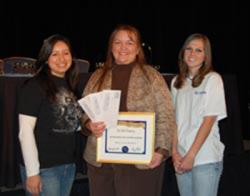 Meagan Saldua (left) and Kristin Peterson (right) pose with their SPS Advisor Dr. Toni Sauncy (center), after she was formally awarded the 2007 SPS Outstanding Chapter Advisor Award at the 2008 AAPT Winter Meeting awards ceremony.