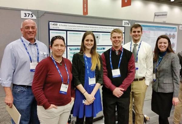 (From left to right) Dr. Rhett Herman, Melissa Brett, Jordan Eagle, Corey Roadcap, Cameron Baumgardner, and Sarah Montgomery pose for a photo in front of their poster presentation. Photo courtesy of Jordan Eagle.
