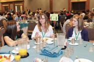 Workshop leader Shelly Arnold (center) visits with students over breakfast at PhysCon 2012.