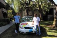 Left to right, SPS alumni Ben Perez and Sandeep Giri pose with one of Google's street-view cars