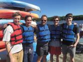 Ian (far left) and Andrew (far right) prepare for a kayaking trip with fellow Tufts researchers.