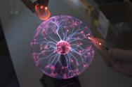 University of Wyoming students brought a fantastic, inexpensive demonstration involving a plasma ball powering nearby  uorescent bulbs.