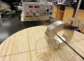 We passed a linear wire through the hole of our suspended magnetic model to measure its dipole moment.